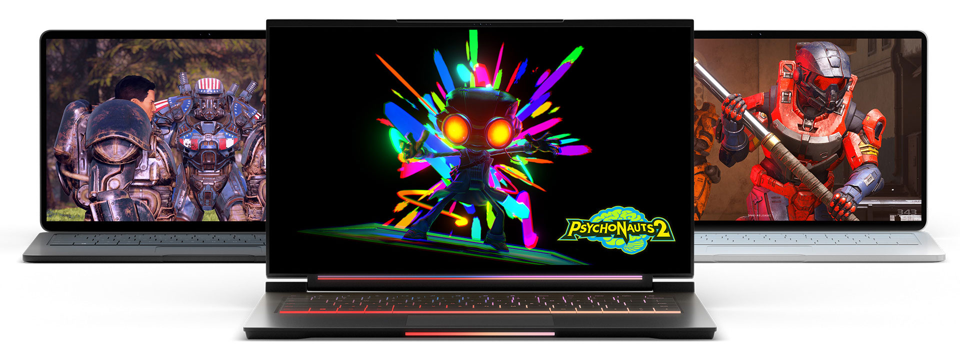 3 laptop computers with video games on screen